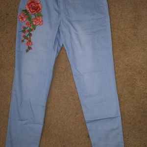 Size medium woman's light blue skinny jean leggings with rose embroidery